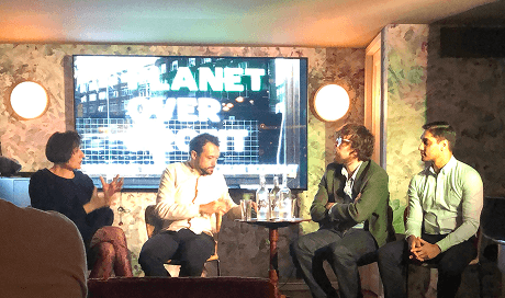 Our founder Randy Rampersad sitting on a panel in front of a screen displaying planet over profit discussing zero waste principles at a Maverick Mondays event in Soho