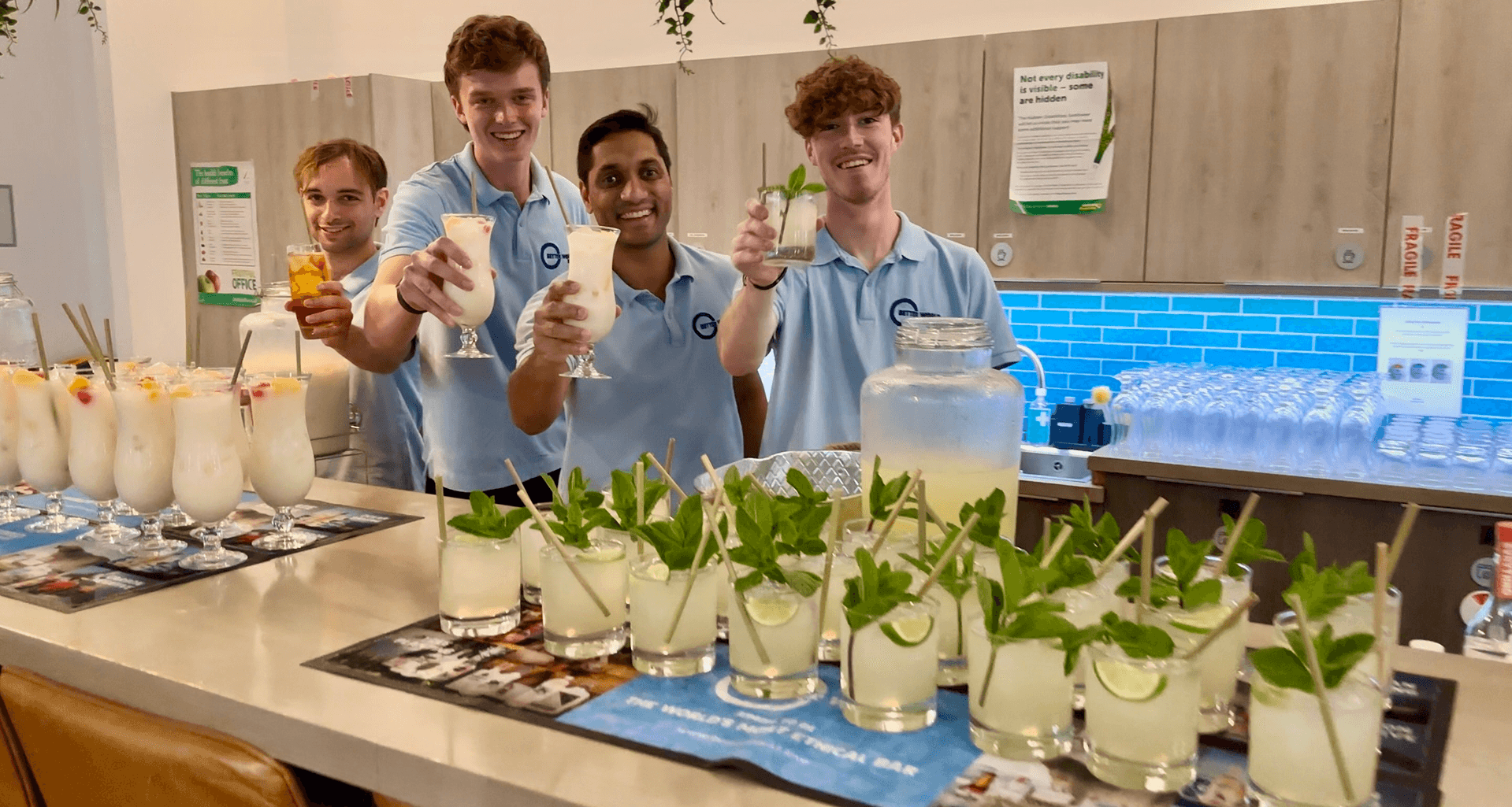 Two smiling bartenders standing behind a glowing digital mobile event bar displaying the Unicef logo representing our measurable social and environmental impact as the award winning most sustainable event bar pouring purpose into every event 2025 Impact Report Thumbnail
